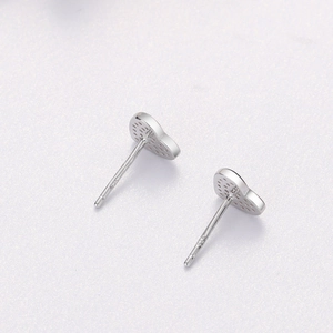 Detailed macro view of S925 sterling silver heart earrings with fine laser hallmark