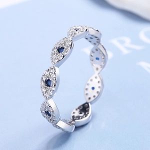 Macro shot of silver Evil Eye ring featuring marquise-shaped links and blue stone pavé