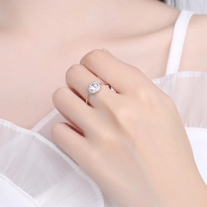 S925 sterling silver halo ring with a round diamond shown on a female model