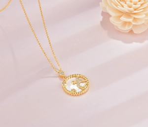 Macro shot of S925 sterling silver Sagittarius coin pendant with white shell and gold chain