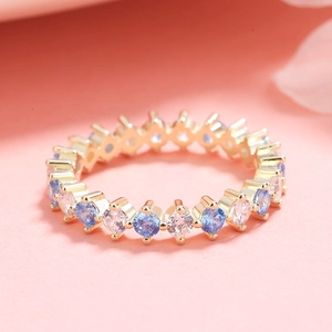 S925 sterling silver ring with blue and white stones on a warm pink background
