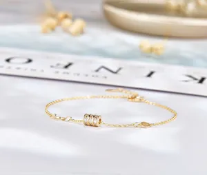 Macro shot of gold-plated 925 silver bracelet featuring a micro-pave diamond waist charm