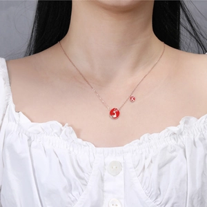 Elegant rose gold deer necklace with red pendant on model for gift ideas