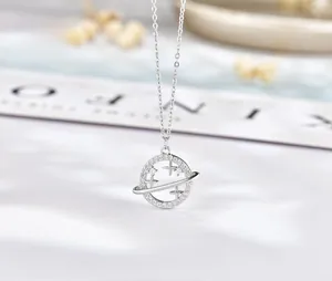 Detail of s925 silver earth planet pendant necklace with sparkling diamond accents