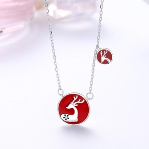 Close-up of S925 sterling silver necklace featuring two red enamel reindeer pendants