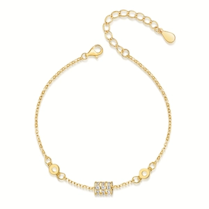Macro view of adjustable gold-plated silver bracelet with micro-pave zircon cylinder charm