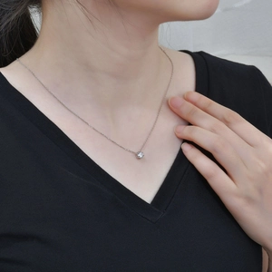 Detail of s925 silver necklace featuring a six-prong sparkling zircon heart on model