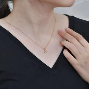 Elegant s925 silver heart necklace with zircon inlay on a model wearing black V-neck top