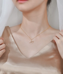 Elegant gold S925 sterling silver planet necklace with crystals on a female model
