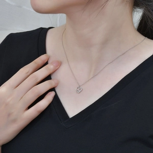 Elegant S925 sterling silver heart necklace with zircon stones on a model's collarbone