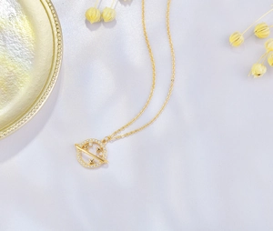 Close-up of a gold S925 sterling silver earth satellite necklace with micro-pave crystals