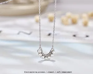 Elegant S925 sterling silver necklace with curved pearl pendant and sparkling crystals