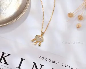 S925 sterling silver Ruyi lock pendant necklace with pavé zircons on silk background
