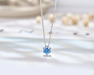 Macro view of blue heart gemstone necklace with six-prong S925 sterling silver setting
