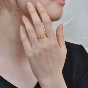 Close-up of golden 925 silver adjustable ring with artistic texture on model finger