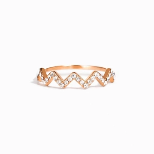 Macro shot of 18K gold plated S925 silver wave ring with pavé-set shimmering zircon stones