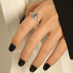 Detailed shot of retro sterling silver lotus ring with purple zircon and teardrop stone