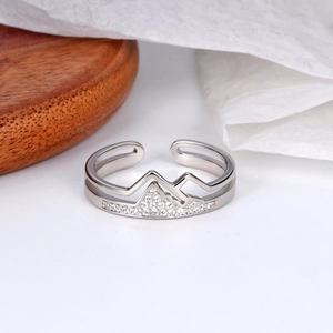 Macro detail of an adjustable silver mountain peak ring set with sparkling zircons