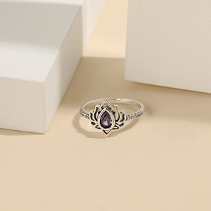 Macro shot of 925 silver lotus ring with purple teardrop zircon and micro-pave details