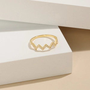 Macro shot of gold-plated wave-shaped S925 silver ring featuring micro-pave cubic zirconia