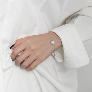 S925 sterling silver heart bracelet with white shell inlay worn on a female wrist