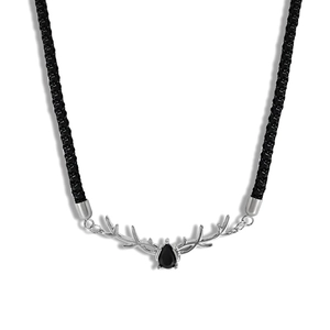 Macro detail of silver reindeer antler necklace with a pear-cut black gemstone and cord