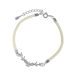 Macro shot of S925 silver deer horn charm with zircon on beige braided rope bracelet