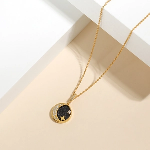 Macro detail of gold starry sky necklace pendant with moon and star zircon inlay
