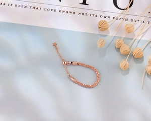 Detail of S925 rose gold adjustable chain ring with star charm and bead slide clasp