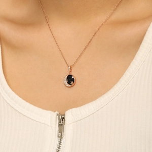 Detailed close-up of rose gold starry sky moon pendant necklace with zircons on model