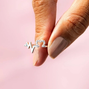 S925 sterling silver heartbeat ring with sparkling zircon heart on pink background