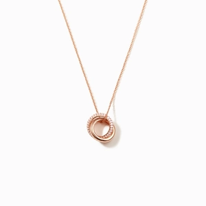 Close-up of interlocking rose gold rings necklace with one circle set in pavé zircon stones