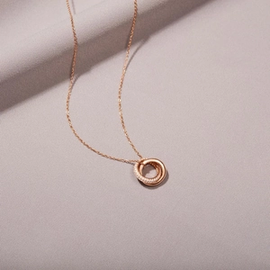 Detail of interlocking circles necklace with rose gold chain and shimmering pavé zircons