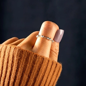 Minimalist S925 sterling silver fidget ring with movable beads worn on the thumb