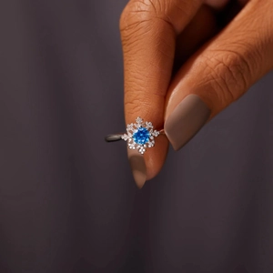 Elegant s925 silver snowflake ring with blue zircon center stone shown on hand