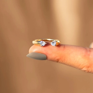 Macro detail of gold-plated silver cuff ring with pear-cut cubic zirconia stones