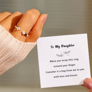 Close-up of gold open heart ring with zircon stones on a mother-daughter gift card