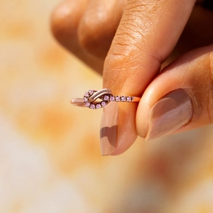Elegant rose gold S925 sterling silver knot ring with sparkling pink gemstones for women
