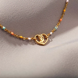 Elegant s925 silver gold heart rose bracelet with colorful enamel beads on a grey background