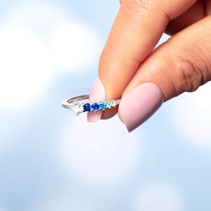 S925 sterling silver shooting star ring with gradient blue crystals on model hand