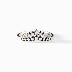 S925 sterling silver crown ring with sparkling zirconia stones on a white background
