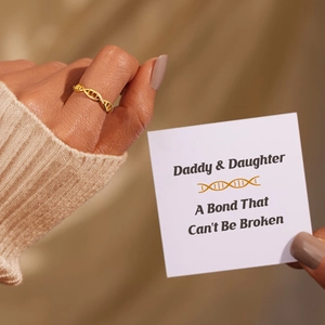 Golden DNA helix ring for women on finger with sentimental gift card for daughter