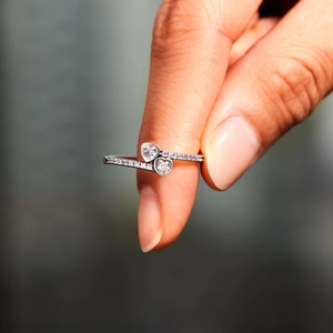 Elegant S925 sterling silver bypass ring with double heart-shaped cubic zirconia stones