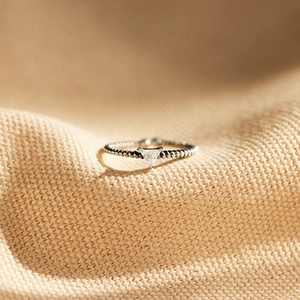Macro shot of S925 sterling silver ring with triangle zircon and beaded texture band