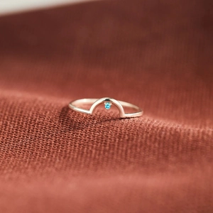 Minimalist S925 sterling silver arched ring with a small dangling blue gemstone