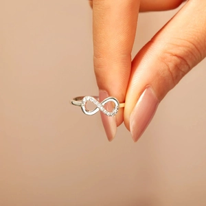 Elegant s925 sterling silver infinity ring with sparkling cubic zirconia on a female finger