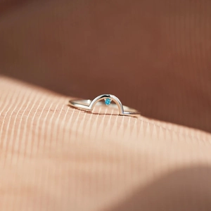 Detailed macro view of S925 sterling silver arch ring featuring a blue gemstone
