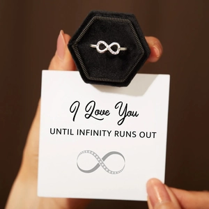 Detail of s925 silver infinity ring with sparkling stones in a black velvet gift box
