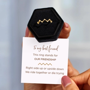 Golden heartbeat wave ring with tiny diamonds in a luxury velvet box with a gift card
