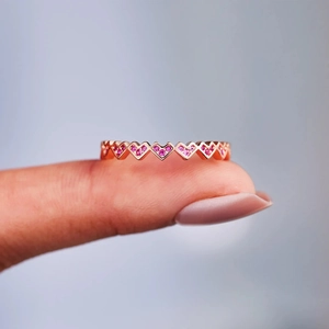 Elegant rose gold eternity ring with heart-shaped pink zircon stones for women